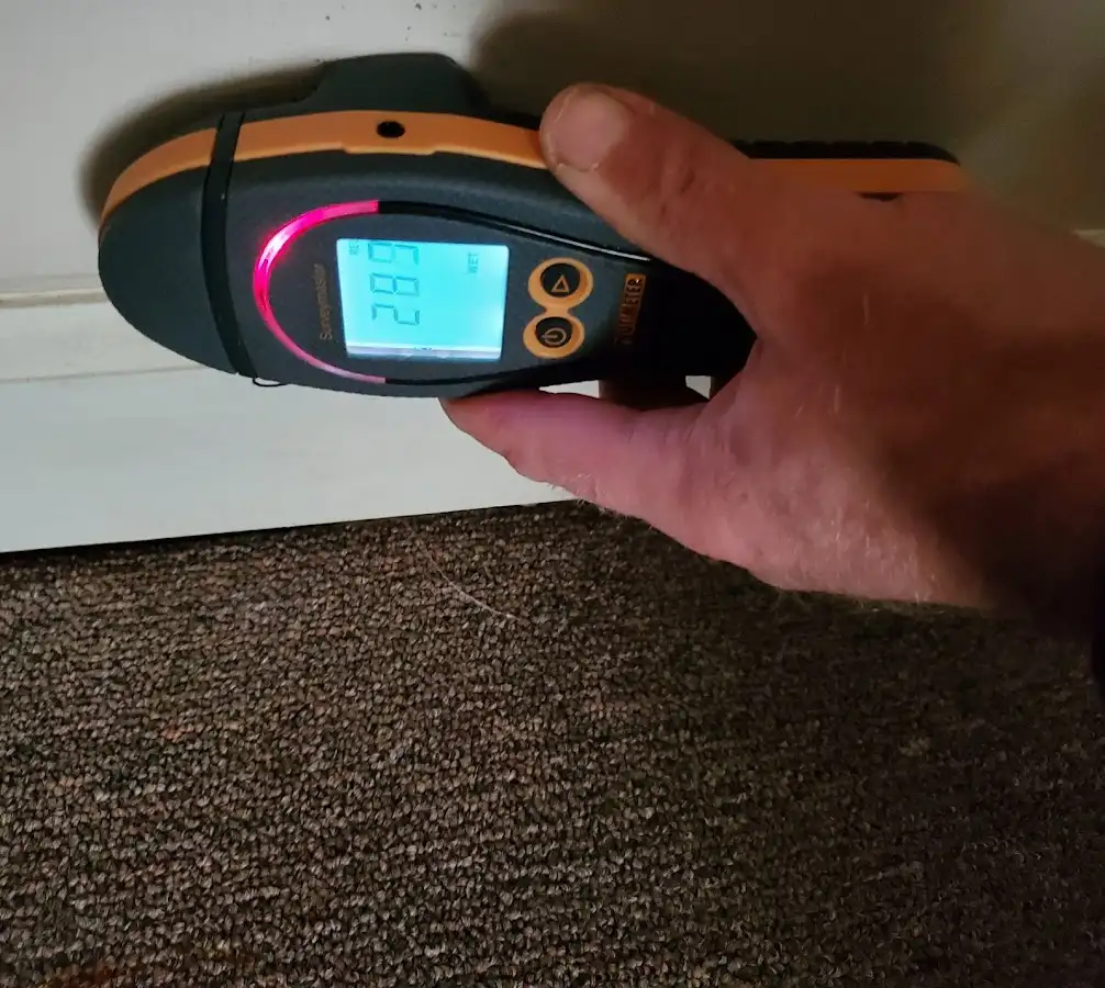 Moisture detection at baseboard during Storm Damage Restoration in Gateway